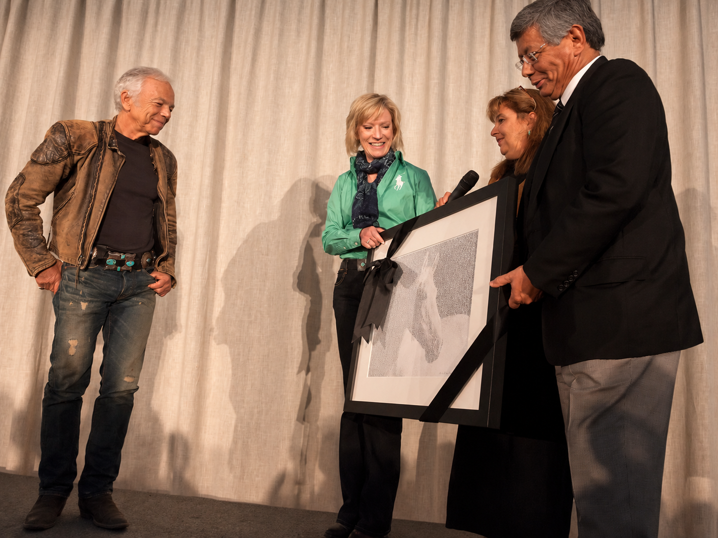 The framed artwork being presented to Ralph Lauren