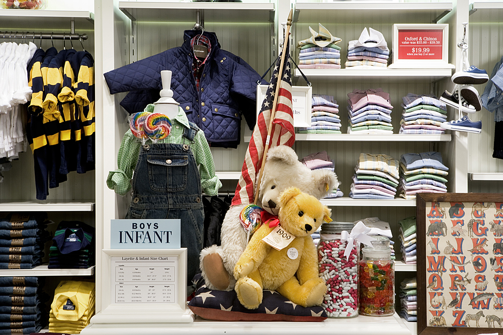 Children's vignette with overalls, teddy bears, an American flag and candy jars