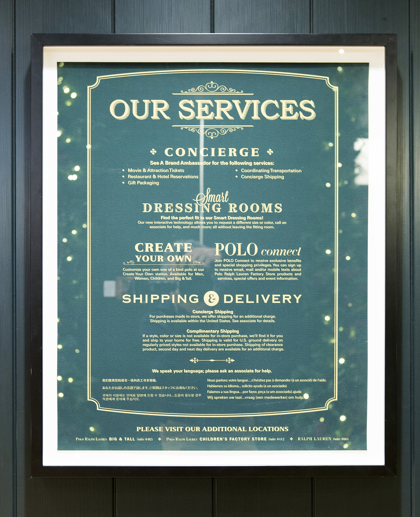 Framed green Our Services sign listing concierge, smart dressing rooms, Create Your Own and shipping