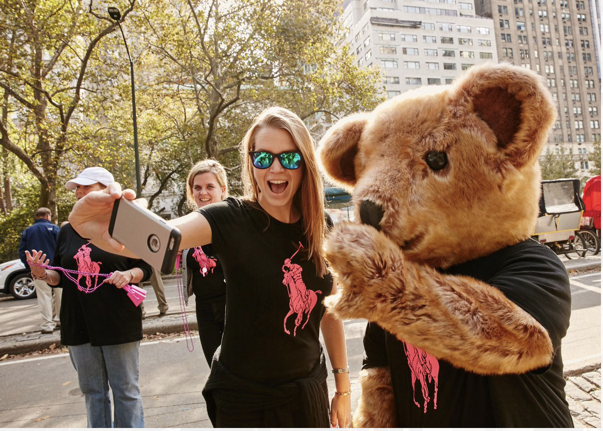 Supporters in Pink Pony tees with the Polo Bear mascot at the Pink Pony Walk in New York City