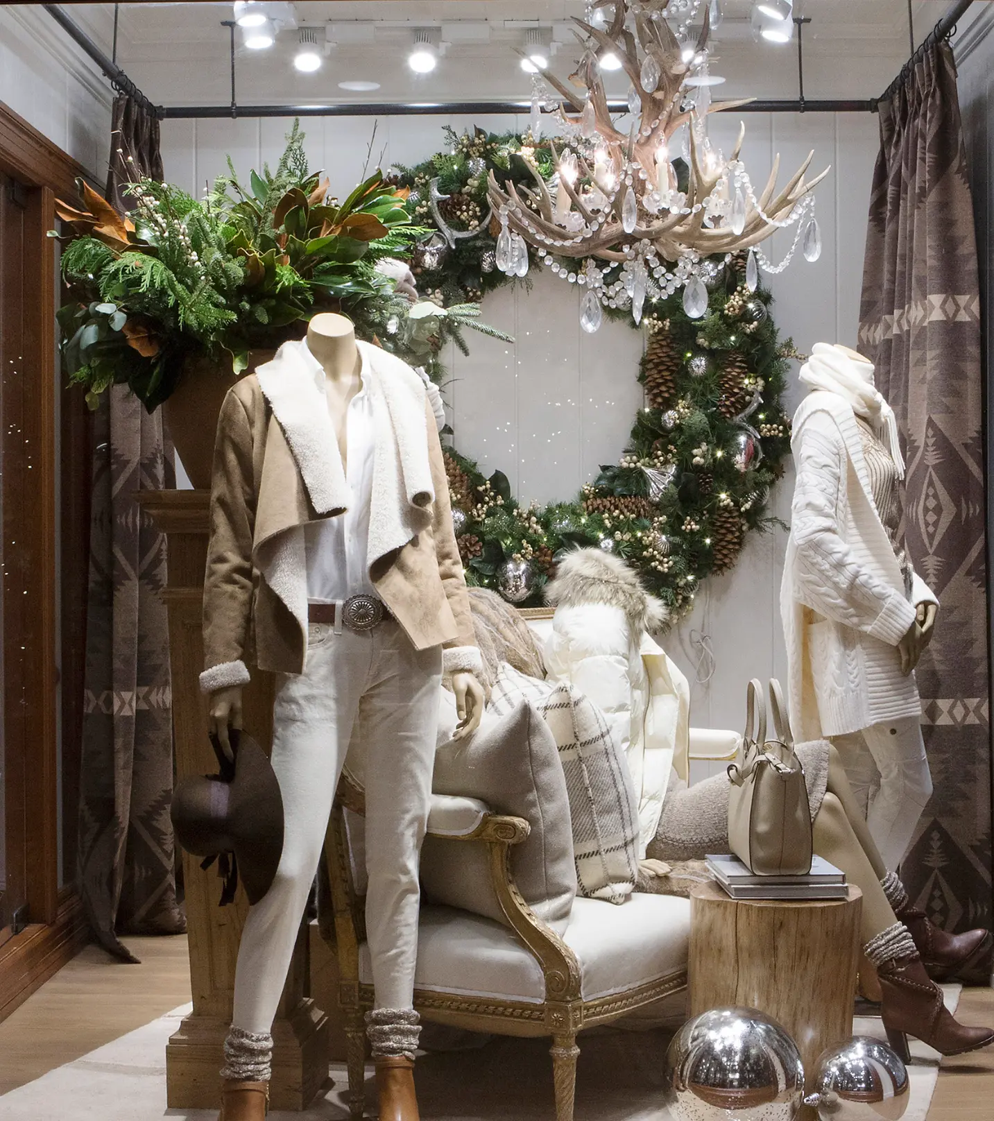 Ralph Lauren Harriman holiday window display with wreath and antler chandelier