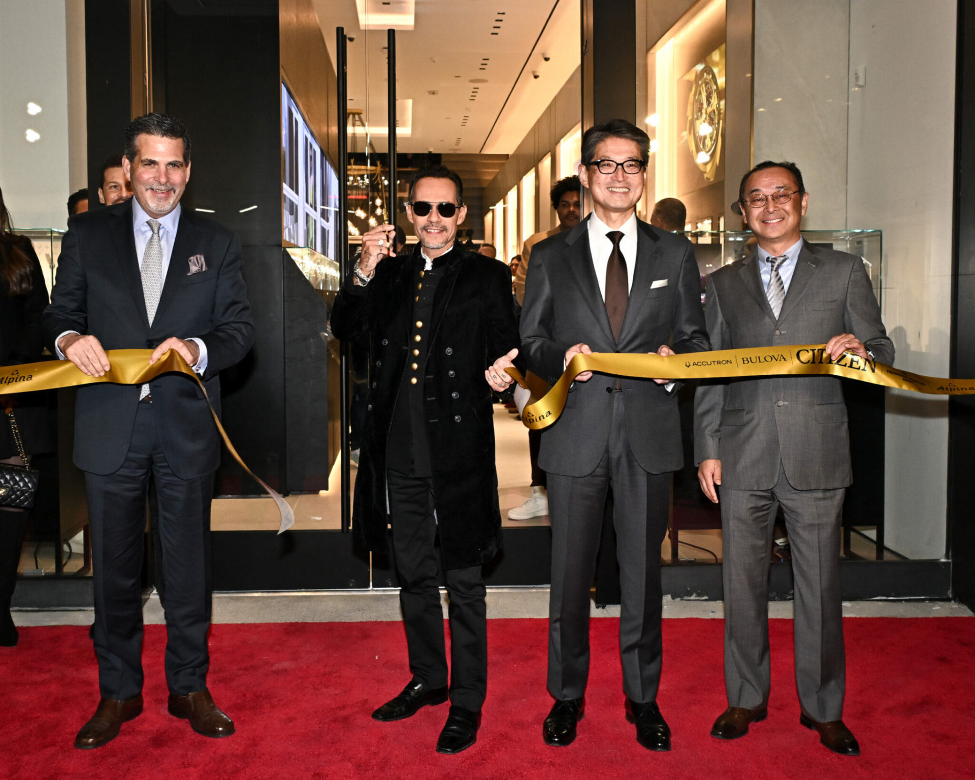 Ribbon-cutting at the Citizen Watch Group flagship opening, with Marc Anthony and company executives on a red carpet