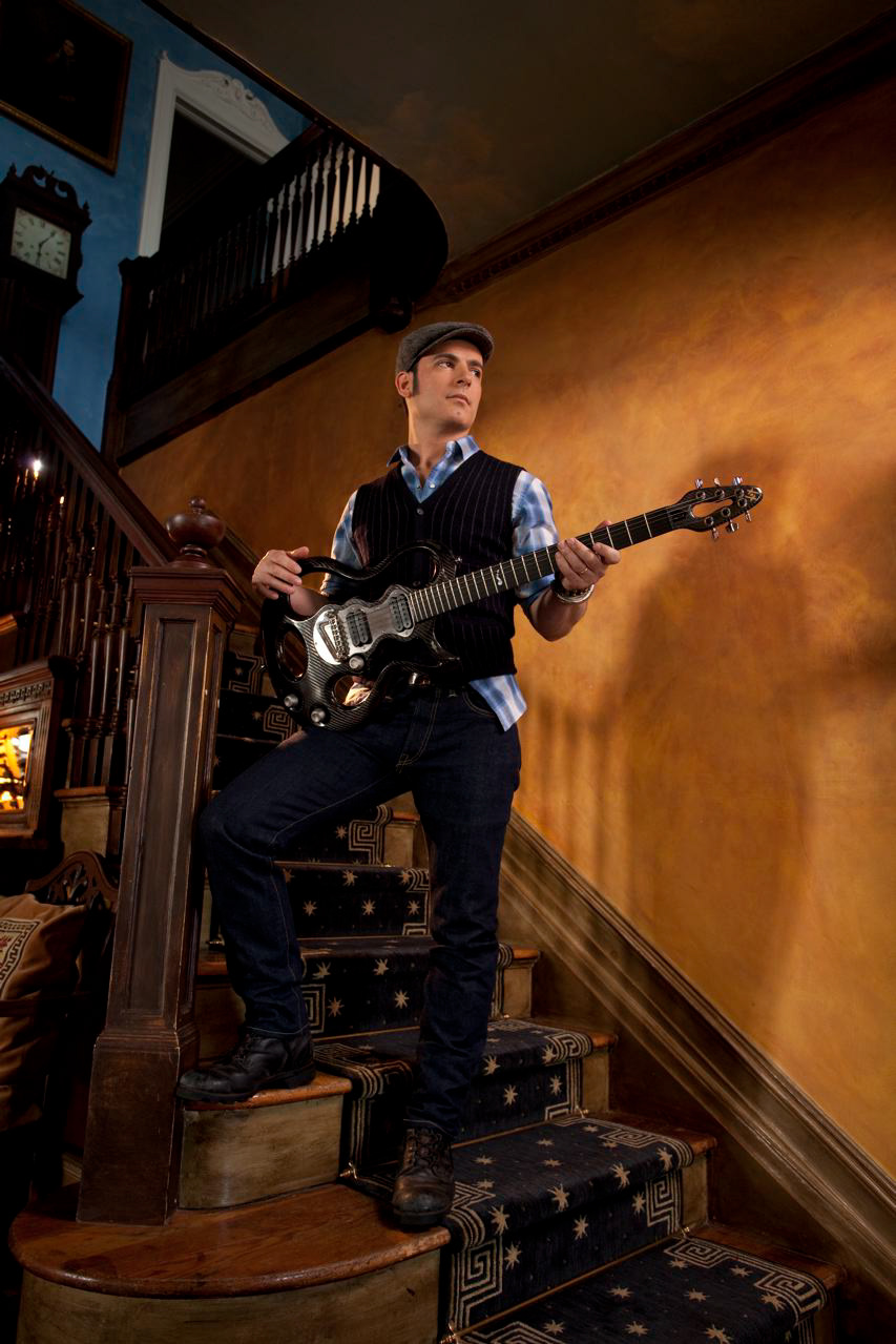 Rod DeGeorge playing guitar at the staircase banister