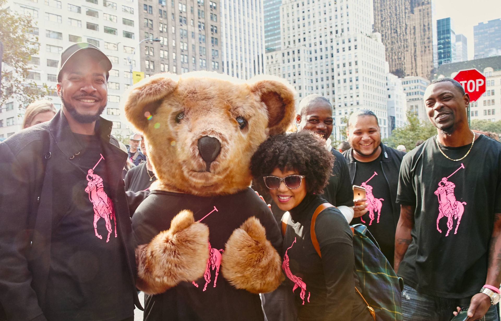 Supporters in Pink Pony tees with the Polo Bear mascot on a New York City street at the Pink Pony Walk