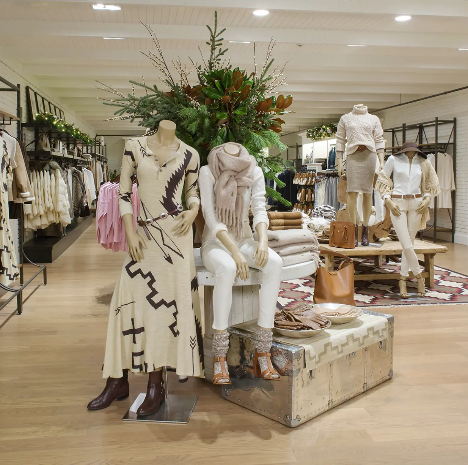 Ralph Lauren store display with southwestern knit dresses and holiday greenery
