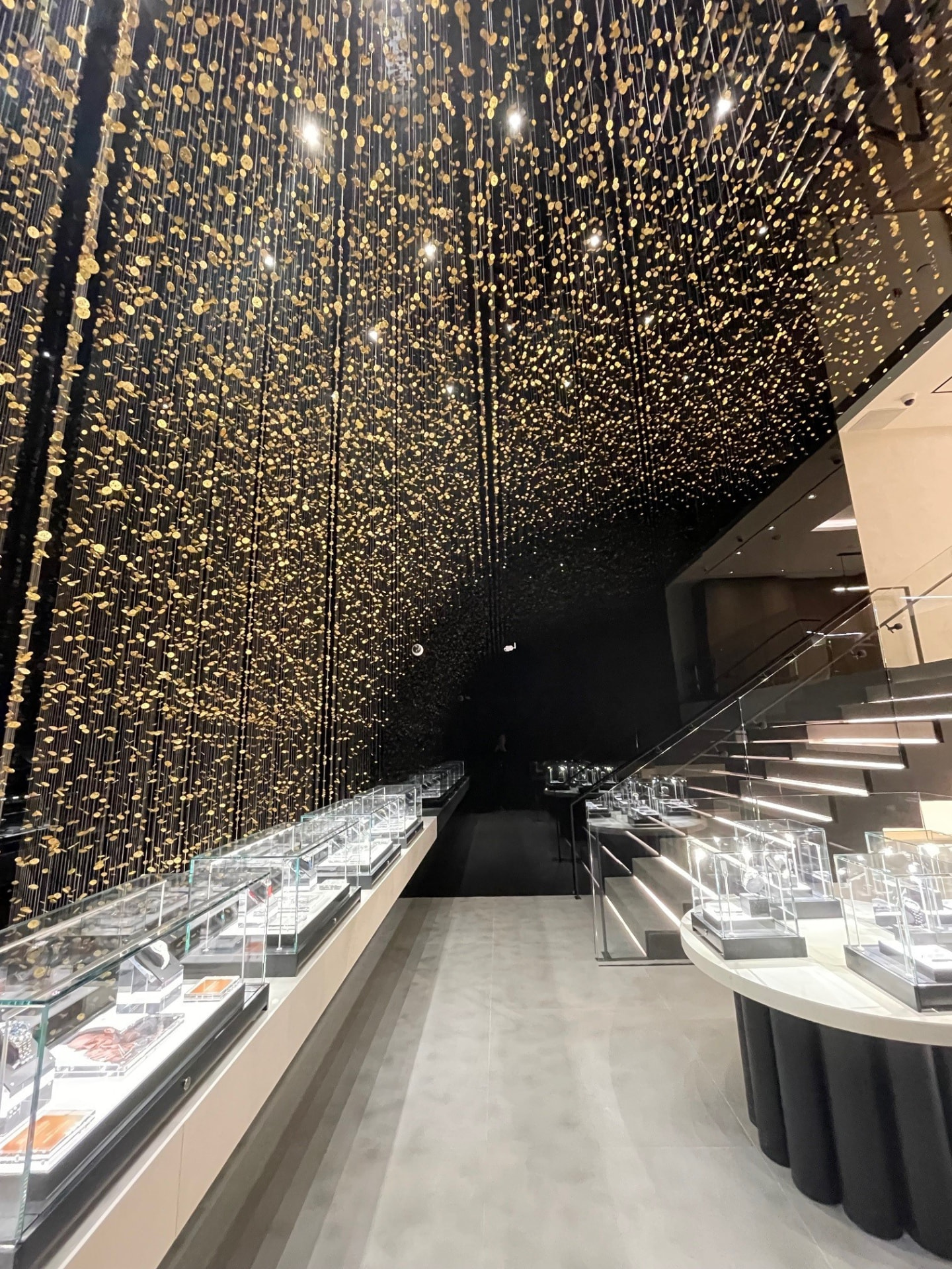 Mezzanine with suspended gold installation, staircase and watch displays