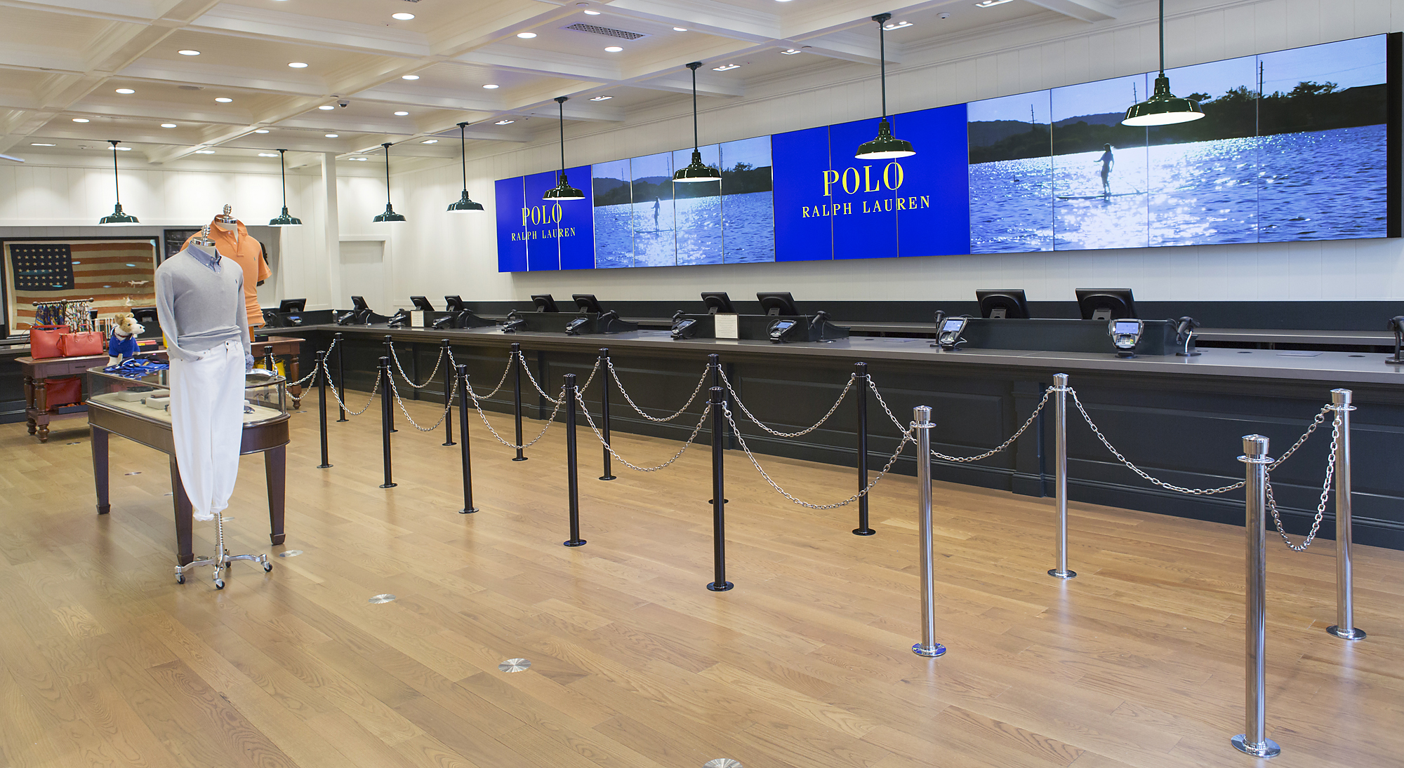 Long blue Polo Ralph Lauren digital display with lake imagery above the checkout counter