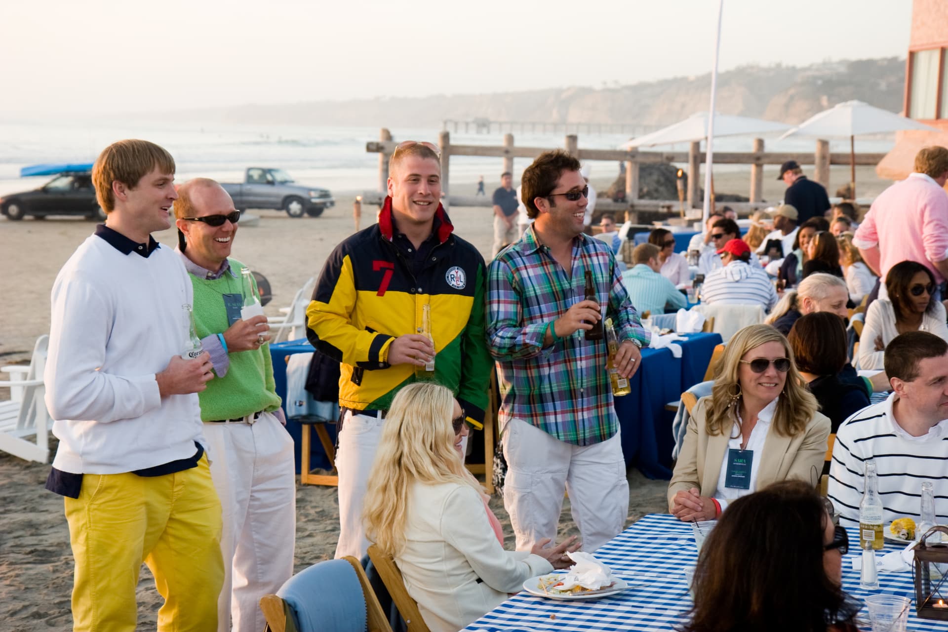 Guests in colorful Ralph Lauren attire mingling at the La Jolla beach event