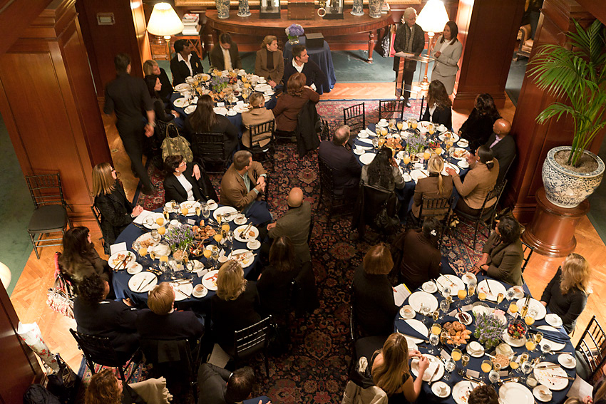 Overhead view of round tables set with blue linens and place settings
