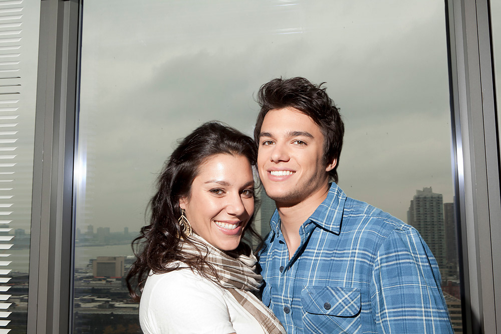 Chris Riggi and his sister by the window above Manhattan