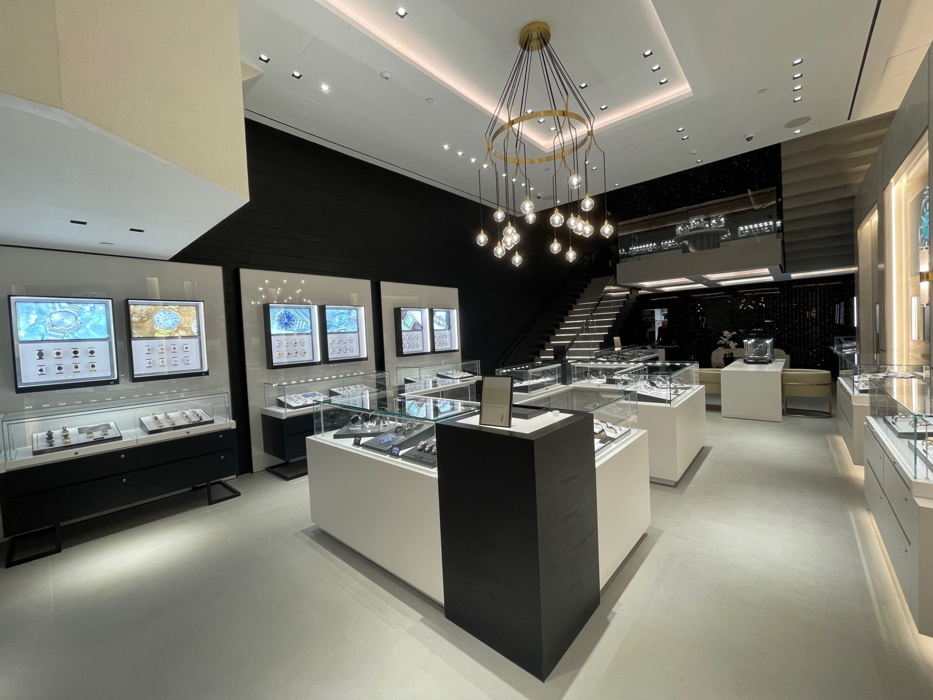 First floor of the Citizen Watch Group New York flagship, with display cases, chandelier and staircase