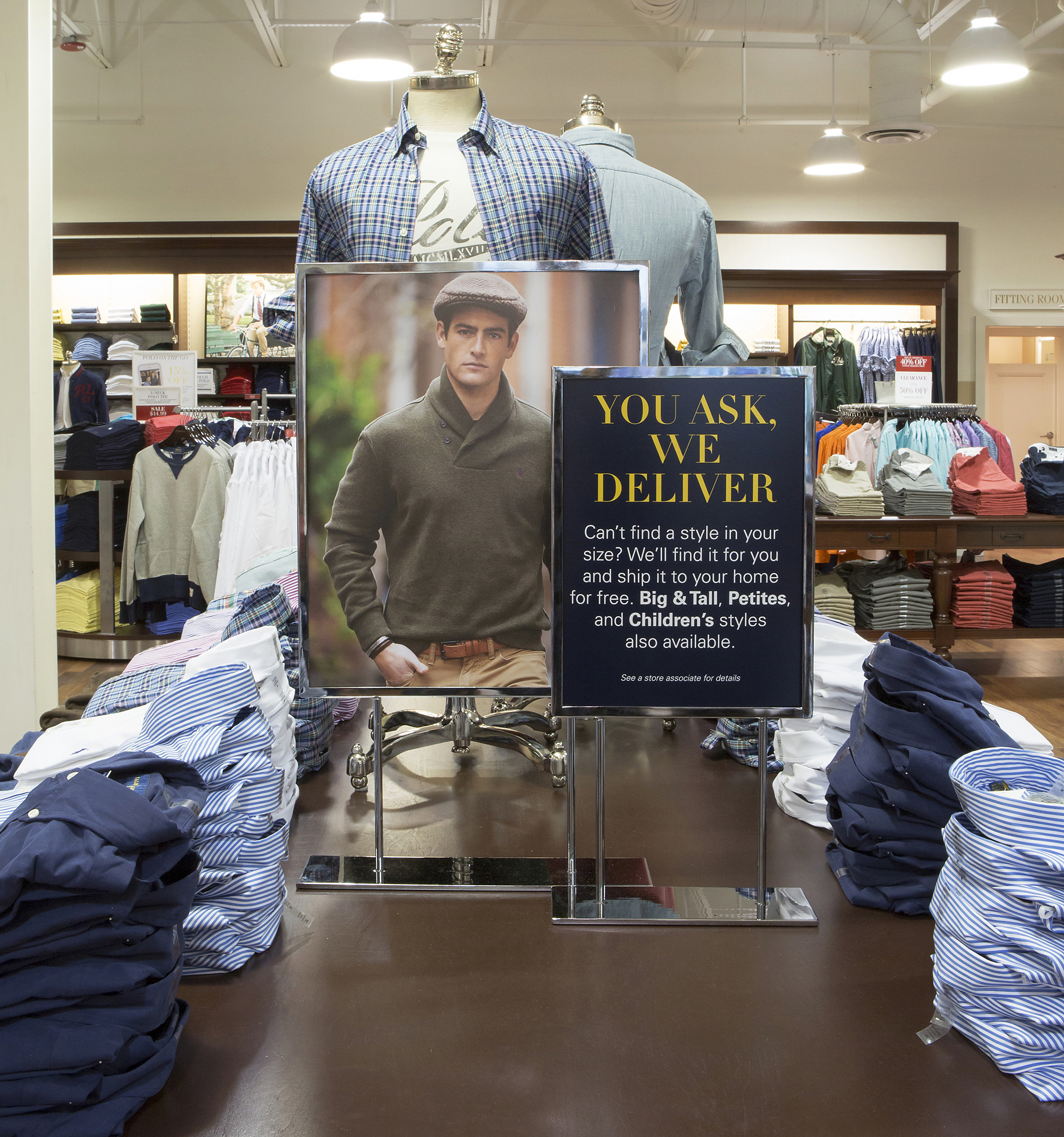 Tabletop You Ask, We Deliver sign beside a lifestyle photograph on a shirting table
