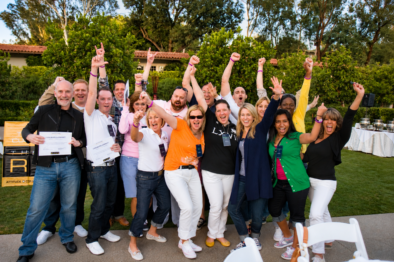 The Ralph Lauren team gathered outdoors celebrating with arms raised at the Las Vegas conference