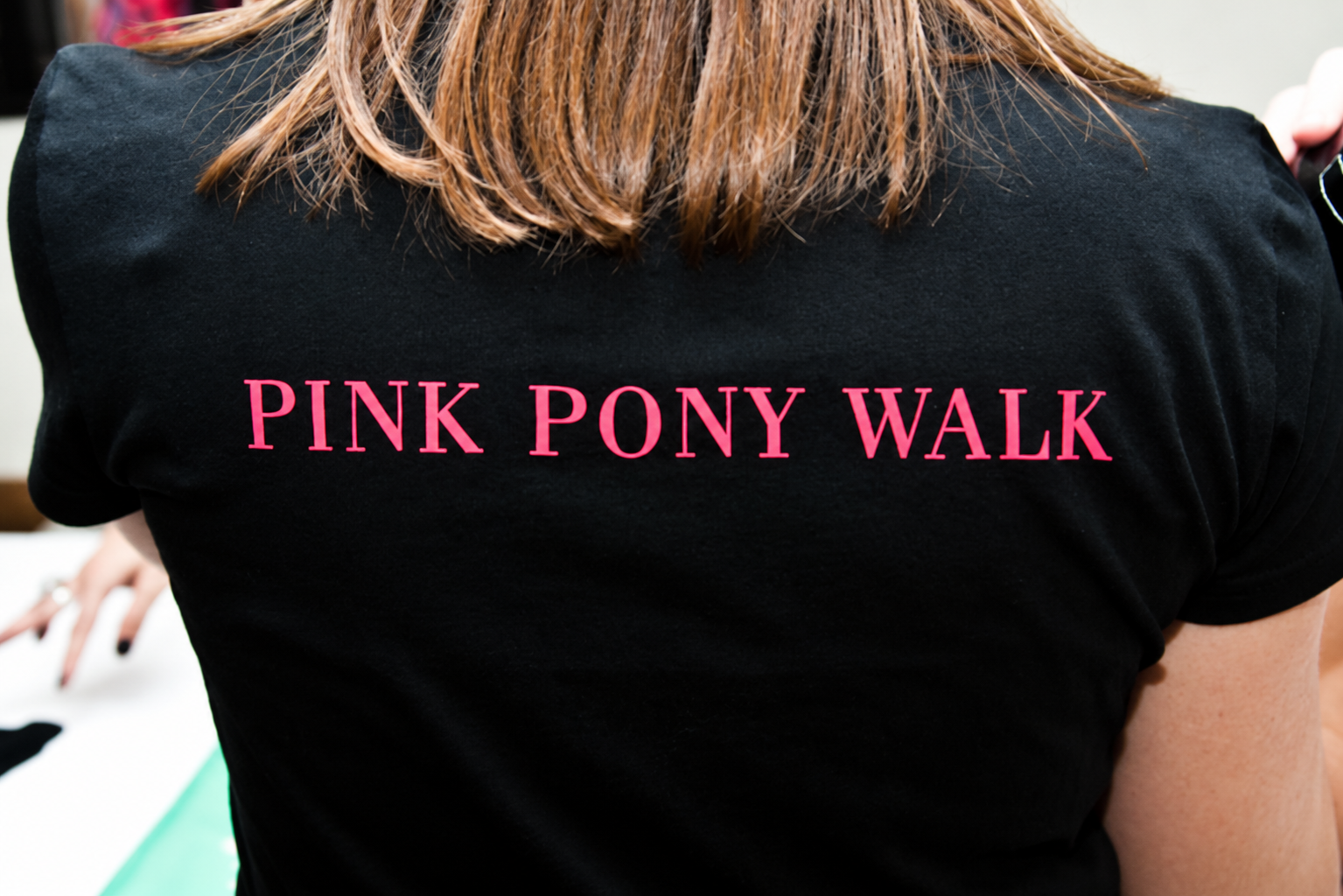 Back of a Pink Pony Walk T-shirt with PINK PONY WALK in pink lettering