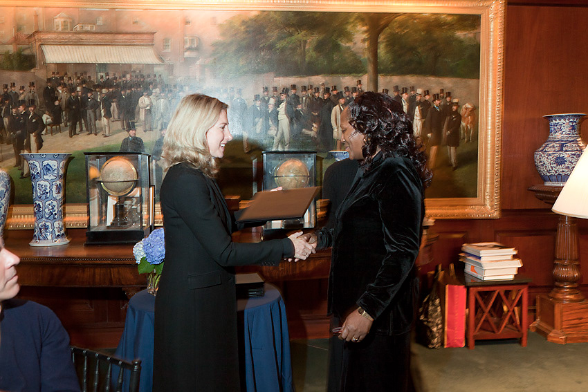 Presentation folder being handed to an honoree